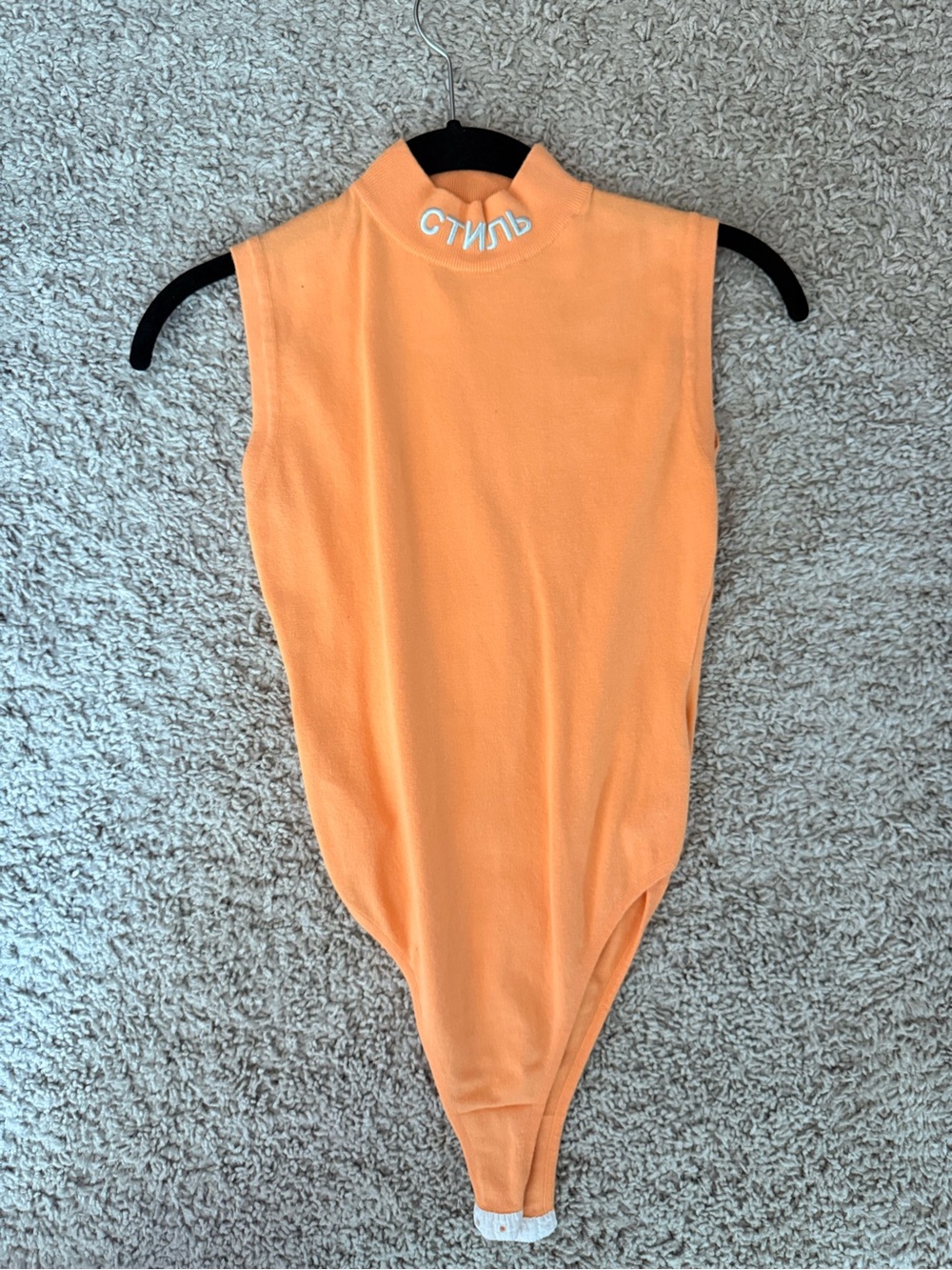 Woman’s Heron Preston Sleeveless Mock Neck One-Piece Bodysuit in Soft Orange